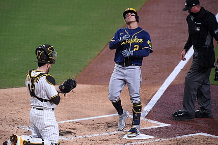 Apr 19, 2021; San Diego, California, USA; Milwaukee Brewers shortstop Luis Urias (2) looks up as he steps on home plate after hitting a home run as San Diego Padres catcher Victor Caratini (17) looks on during the third inning at Petco Park. Mandatory Credit: Orlando Ramirez-USA TODAY Sports