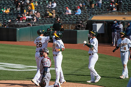 Apr 20, 2021; Oakland, California, USA;  Oakland Athletics first baseman Matt Olson (28) celebrates after hitting a grand slam home run with Oakland Athletics shortstop Elvis Andrus (17) and teammates during the fourth inning |T at RingCentral Coliseum. Mandatory Credit: Neville E. Guard-USA TODAY Sports