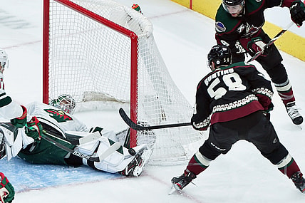 Apr 21, 2021; Glendale, Arizona, USA;  Minnesota Wild goaltender Cam Talbot (33) makes a save against Arizona Coyotes left wing Michael Bunting (58) during the first period at Gila River Arena. Mandatory Credit: Matt Kartozian-USA TODAY Sports