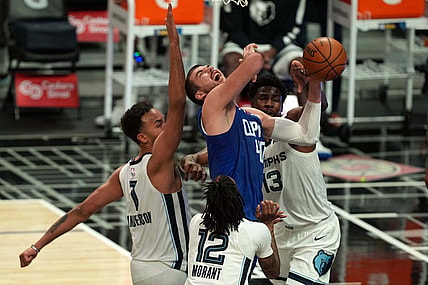 Apr 21, 2021; Los Angeles, California, USA; LA Clippers center Ivica Zubac (40) is defended by Memphis Grizzlies forward Kyle Anderson (1), forward Jaren Jackson Jr. (13) and Ja Morantin the first half at Staples Center. Mandatory Credit: Kirby Lee-USA TODAY Sports