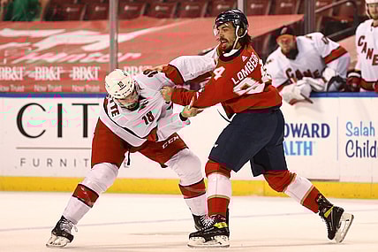 Apr 22, 2021; Sunrise, Florida, USA; Carolina Hurricanes center Cedric Paquette (18) and Florida Panthers left wing Ryan Lomberg (94) fight during the first period at BB&T Center. Mandatory Credit: Sam Navarro-USA TODAY Sports