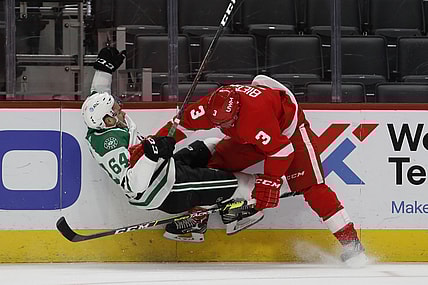 Apr 22, 2021; Detroit, Michigan, USA; Detroit Red Wings defenseman Alex Biega (3) body checks Dallas Stars center Tanner Kero (64) during the first period at Little Caesars Arena. Mandatory Credit: Raj Mehta-USA TODAY Sports