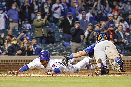 Apr 22, 2021; Chicago, Illinois, USA; Chicago Cubs catcher Willson Contreras (40) scores as New York Mets catcher James McCann (33) applies a late tag during the third inning at Wrigley Field. Mandatory Credit: Kamil Krzaczynski-USA TODAY Sports