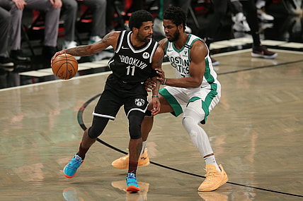 Apr 23, 2021; Brooklyn, New York, USA; Brooklyn Nets point guard Kyrie Irving (11) dribbles the ball while defended by Boston Celtics power forward Semi Ojeleye (37) during the first quarter at Barclays Center. Mandatory Credit: Brad Penner-USA TODAY Sports