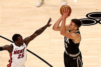 Apr 23, 2021; Atlanta, Georgia, USA; Atlanta Hawks guard Bogdan Bogdanovic (13) attempts a three-point basket against Miami Heat guard Kendrick Nunn (25) during the first quarter at State Farm Arena. Mandatory Credit: Jason Getz-USA TODAY Sports