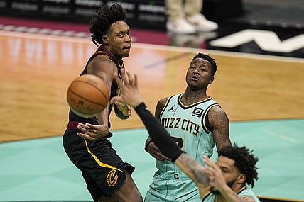 Apr 23, 2021; Charlotte, North Carolina, USA; Cleveland Cavaliers guard Collin Sexton (L) passes the ball in front of Charlotte Hornets guard Terry Rozier (C) during the first quarter at the Spectrum Center. Mandatory Credit: Jim Dedmon-USA TODAY Sports