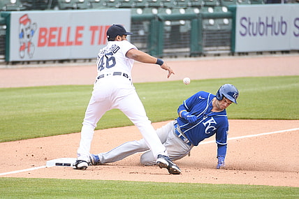 Apr 24, 2021; Detroit, Michigan, USA; Kansas City Royals left fielder Andrew Benintendi (16) slides in safe at third base as Detroit Tigers third baseman Jeimer Candelario (46) is unable to make the play during the fifth inning at Comerica Park. Mandatory Credit: Tim Fuller-USA TODAY Sports