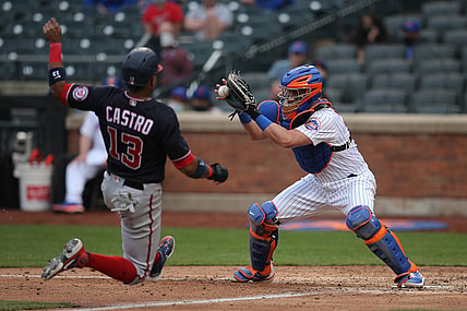 Apr 24, 2021; New York City, New York, USA; Washington Nationals infielder Starlin Castro (13) is tagged out trying to score by New York Mets catcher James McCann (33) on a bunt by Nationals starting pitcher Joe Ross (not pictured) during the fifth inning at Citi Field. Mandatory Credit: Brad Penner-USA TODAY Sports
