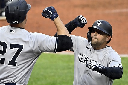 Apr 24, 2021; Cleveland, Ohio, USA; New York Yankees second baseman Rougned Odor (right) celebrates with designated hitter Giancarlo Stanton (27) after hitting a solo home run against the Cleveland Indians in the fifth inning at Progressive Field. Mandatory Credit: David Richard-USA TODAY Sports