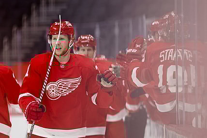 Apr 24, 2021; Detroit, Michigan, USA; Detroit Red Wings defenseman Dennis Cholowski (21) is congratulated by teammates after scoring against the Dallas Stars in the first period at Little Caesars Arena. Mandatory Credit: Rick Osentoski-USA TODAY Sports