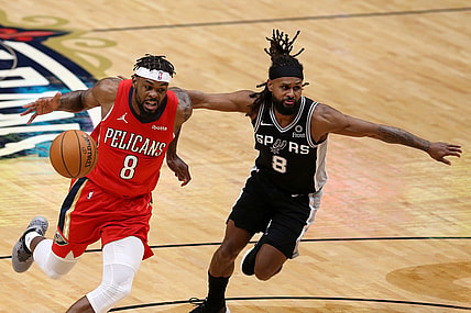 Apr 24, 2021; New Orleans, Louisiana, USA; New Orleans Pelicans forward Naji Marshall (left) dribbles the ball against San Antonio Spurs guard Patty Mills (right) during the first quarter at the Smoothie King Center. Mandatory Credit: Chuck Cook-USA TODAY Sports