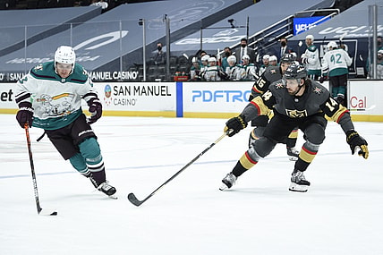 Apr 24, 2021; Anaheim, California, USA; Anaheim Ducks center Sam Steel (23) handles the puck while Vegas Golden Knights defenseman Nicolas Hague (14) defends during the first period at Honda Center. Mandatory Credit: Kelvin Kuo-USA TODAY Sports