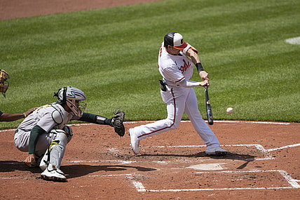 Apr 25, 2021; Baltimore, Maryland, USA; Baltimore Orioles right fielder Austin Hays (21) hits a home run during the fourth inning against the Oakland Athletics at Oriole Park at Camden Yards. Mandatory Credit: Gregory Fisher-USA TODAY Sports