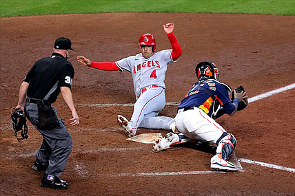 Apr 25, 2021; Houston, Texas, USA; Los Angeles Angels shortstop Jose Iglesias (4) slides across home plate to score a run against the Houston Astros during the fifth inning at Minute Maid Park. Mandatory Credit: Erik Williams-USA TODAY Sports