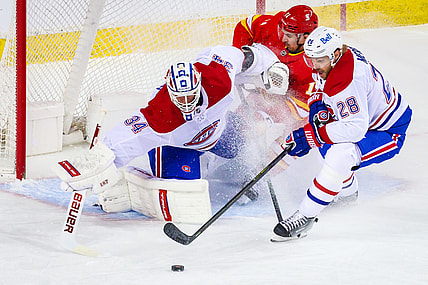 Apr 26, 2021; Calgary, Alberta, CAN; Montreal Canadiens goaltender Jake Allen (34) makes a save against Calgary Flames center Mikael Backlund (11) during the first period at Scotiabank Saddledome. Mandatory Credit: Sergei Belski-USA TODAY Sports