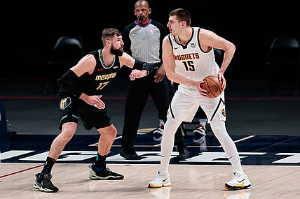 Apr 26, 2021; Denver, Colorado, USA; Denver Nuggets center Nikola Jokic (15) controls the ball as Memphis Grizzlies center Jonas Valanciunas (17) guards in the first quarter at Ball Arena. Mandatory Credit: Isaiah J. Downing-USA TODAY Sports