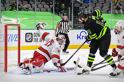 Apr 26, 2021; Dallas, Texas, USA; Dallas Stars left wing Jamie Benn (14) scores the game winning goal against Carolina Hurricanes goaltender James Reimer (47) during the overtime period at the American Airlines Center. Mandatory Credit: Jerome Miron-USA TODAY Sports