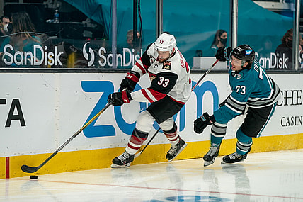 Apr 26, 2021; San Jose, California, USA; Arizona Coyotes defenseman Alex Goligoski (33 and San Jose Sharks center Noah Gregor (73) battle for the puck behind the net during the second period at SAP Center at San Jose. Mandatory Credit: Neville E. Guard-USA TODAY Sports