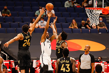 Apr 27, 2021; Tampa, Florida, USA;  Brooklyn Nets forward Kevin Durant (7) shoots through defenders Toronto Raptors forward OG Anunoby (3) and  center Khem Birch (24) in the first quarter at Amalie Arena. Mandatory Credit: Nathan Ray Seebeck-USA TODAY Sports