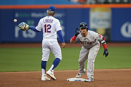 Apr 28, 2021; New York City, New York, USA; Boston Red Sox catcher  Christian Vazquez (7) reacts after his RBI double as New York Mets shortstop Francisco Lindor (12) takes the throw from the outfield during the second inning at Citi Field. Mandatory Credit: Brad Penner-USA TODAY Sports