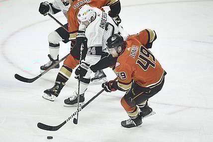 Apr 28, 2021; Los Angeles, California, USA; Los Angeles Kings center Lias Andersson (24) moves the puck while defended by Anaheim Ducks left wing Max Jones (49) during the first period at Staples Center. Mandatory Credit: Kelvin Kuo-USA TODAY Sports