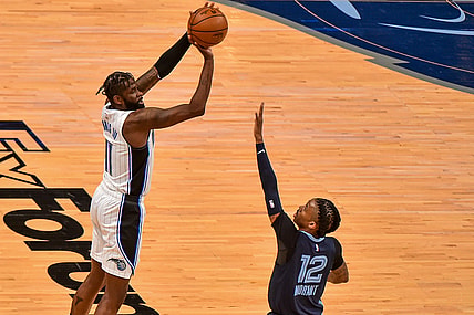 Apr 30, 2021; Memphis, Tennessee, USA; Orlando Magic forward James Ennis III (11) shoots against Memphis Grizzlies guard Ja Morant (12) during the first half at FedExForum. Mandatory Credit: Justin Ford-USA TODAY Sports