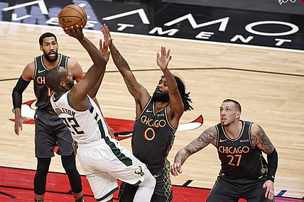 Apr 30, 2021; Chicago, Illinois, USA; Milwaukee Bucks forward Khris Middleton (22) shoots against Chicago Bulls guard Coby White (0) during the first half of an NBA basketball game at United Center. Mandatory Credit: Kamil Krzaczynski-USA TODAY Sports