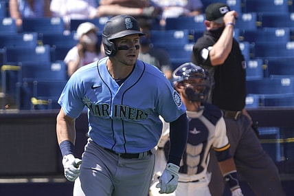Mar 21, 2021; Phoenix, Arizona, USA; Seattle Mariners centerfielder Jarred Kelenic (10) hits a homerun against the Milwaukee Brewers during a spring training game at American Family Fields of Phoenix. Mandatory Credit: Rick Scuteri-USA TODAY Sports