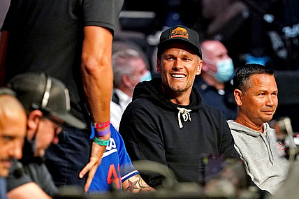 Apr 24, 2021; Jacksonville, Florida, USA; Tampa Bay Buccaneers quarterback Tom Brady looks on before Alex Oliveira (Red Gloves) fights Randy Brown (Blue Gloves) during UFC 261 at VyStar Veterans Memorial Arena. Mandatory Credit: Jasen Vinlove-USA TODAY Sports