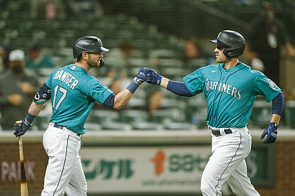 Apr 30, 2021; Seattle, Washington, USA; Seattle Mariners designated hitter Tom Murphy (2) bumps fists with right fielder Mitch Haniger (17) after digging a solo-home run against the Los Angeles Angels during the fourth inning at T-Mobile Park. Mandatory Credit: Joe Nicholson-USA TODAY Sports