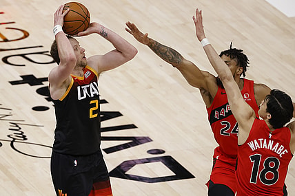 May 1, 2021; Salt Lake City, Utah, USA; Utah Jazz guard Joe Ingles (2) shoots for three points against Toronto Raptors center Khem Birch (24) and forward Yuta Watanabe (18) in the second quarter at Vivint Arena. Mandatory Credit: Jeffrey Swinger-USA TODAY Sports