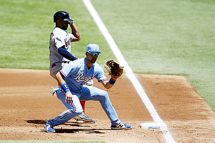 May 2, 2021; Arlington, Texas, USA; Boston Red Sox shortstop Xander Bogaerts (2) is safe at first as Texas Rangers first baseman Nate Lowe (30) catches the ball in the second inning at Globe Life Field. Mandatory Credit: Tim Heitman-USA TODAY Sports