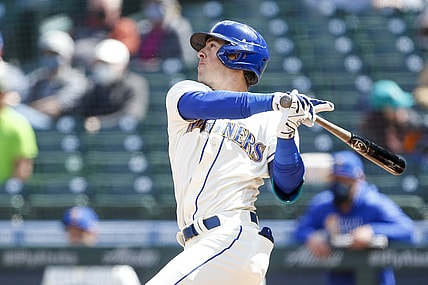May 2, 2021; Seattle, Washington, USA; Seattle Mariners second baseman Dylan Moore (25) hits an RBI-single against the Los Angeles Angels during the fourth inning at T-Mobile Park. Mandatory Credit: Joe Nicholson-USA TODAY Sports