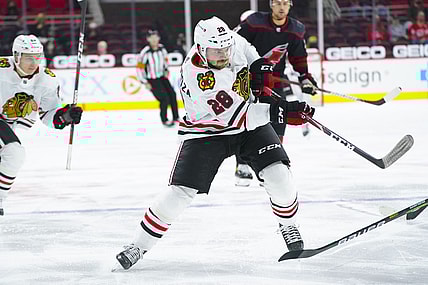 May 3, 2021; Raleigh, North Carolina, USA;  Chicago Blackhawks left wing Vinnie Hinostroza (28) takes a shot during the second period against the Carolina Hurricanes at PNC Arena. Mandatory Credit: James Guillory-USA TODAY Sports