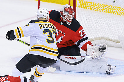 May 4, 2021; Newark, New Jersey, USA; New Jersey Devils goaltender Mackenzie Blackwood (29) makes a glove save in front of Boston Bruins center Patrice Bergeron (37) during the first period at Prudential Center. Mandatory Credit: Vincent Carchietta-USA TODAY Sports