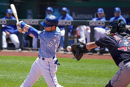 May 6, 2021; Kansas City, Missouri, USA; With Kansas City Royals left fielder Andrew Benintendi (16) swings at a pitch as Cleveland Indians catcher Rene Rivera (46) attempts to make a throw to second base but drops the ball in the first inning at Kauffman Stadium. Mandatory Credit: Denny Medley-USA TODAY Sports