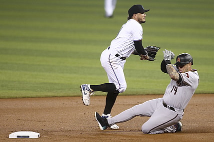 May 6, 2021; Miami, Florida, USA; Miami Marlins shortstop Miguel Rojas (19) throws to first after forcing out Arizona Diamondbacks third baseman Asdrubal Cabrera (14) during the first inning at loanDepot park. Mandatory Credit: Sam Navarro-USA TODAY Sports
