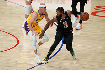 May 6, 2021; Los Angeles, California, USA; LA Clippers guard Paul George (13) handles the ball while defended by Los Angeles Lakers guard Alex Caruso (4) in the first half at Staples Center. Mandatory Credit: Kirby Lee-USA TODAY Sports