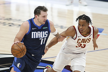 May 7, 2021; Dallas, Texas, USA; Dallas Mavericks guard Luka Doncic (77) drives against Cleveland Cavaliers guard Brodric Thomas (33) during the first quarter at American Airlines Center. Mandatory Credit: Tim Heitman-USA TODAY Sports