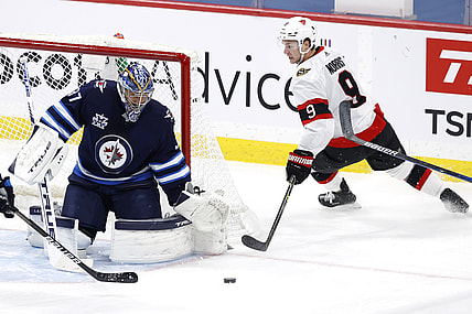 May 8, 2021; Winnipeg, Manitoba, CAN;  Winnipeg Jets goaltender Connor Hellebuyck (37) blocks a shot by Ottawa Senators center Josh Norris (9) in the first period at Bell MTS Place. Mandatory Credit: James Carey Lauder-USA TODAY Sports
