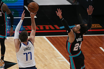 May 11, 2021; Memphis, Tennessee, USA; Memphis Grizzlies forward Dillon Brooks (24) defends Dallas Mavericks guard Luka Don  i   (77) during the first quarter  at FedExForum. Mandatory Credit: Petre Thomas-USA TODAY Sports