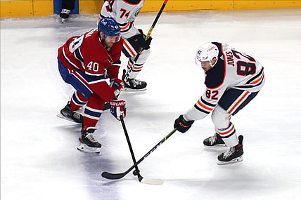 May 12, 2021; Montreal, Quebec, CAN; Montreal Canadiens right wing Joel Armia (40) and Edmonton Oilers defenseman Caleb Jones (82) battle for the puck during the second period at Bell Centre. Mandatory Credit: Jean-Yves Ahern-USA TODAY Sports