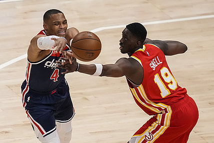 May 12, 2021; Atlanta, Georgia, USA; Washington Wizards guard Russell Westbrook (4) is fouled while passing against Atlanta Hawks forward Tony Snell (19) during the first quarter at State Farm Arena. Mandatory Credit: Dale Zanine-USA TODAY Sports