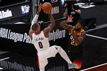 May 12, 2021; Salt Lake City, Utah, USA; Portland Trail Blazers guard Damian Lillard (0) shoots a fade jump shot away from Utah Jazz forward Royce O'Neale (23) during the second quarter at Vivint Arena. Mandatory Credit: Chris Nicoll-USA TODAY Sports