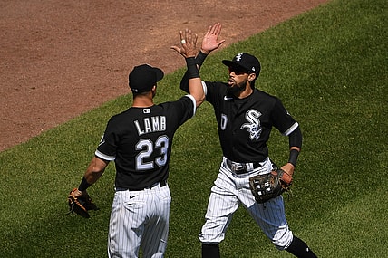 May 13, 2021; Chicago, Illinois, USA; Chicago White Sox center fielder Billy Hamilton (0) celebrates with Chicago White Sox first baseman Jake Lamb (23) after his catch at the wall in the fourth inning against the Minnesota Twins at Guaranteed Rate Field. Mandatory Credit: Quinn Harris-USA TODAY Sports