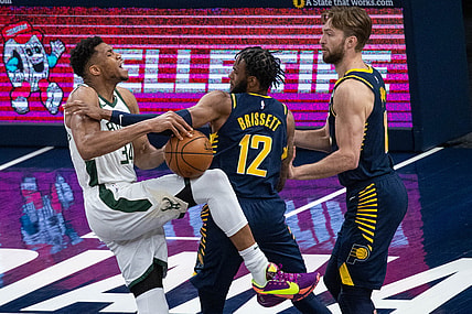 May 13, 2021; Indianapolis, Indiana, USA; Milwaukee Bucks forward Giannis Antetokounmpo (34) is fouled by Indiana Pacers forward Oshae Brissett (12) in the third quarter at Bankers Life Fieldhouse. Mandatory Credit: Trevor Ruszkowski-USA TODAY Sports