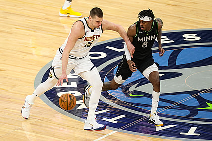 May 13, 2021; Minneapolis, Minnesota, USA; Denver Nuggets center Nikola Jokic (15) dribbles the ball while Minnesota Timberwolves forward Jarred Vanderbilt (8) defends in the first quarter at Target Center. Mandatory Credit: David Berding-USA TODAY Sports