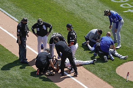 May 14, 2021; Chicago, Illinois, USA; Chicago White Sox first baseman Jose Abreu (79) and Kansas City Royals third baseman Hunter Dozier (17) lay on the field after colliding along the first base line during the second inning of the first game of a doubleheader at Guaranteed Rate Field. Mandatory Credit: Kamil Krzaczynski-USA TODAY Sports