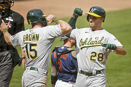 May 15, 2021; Minneapolis, Minnesota, USA; Oakland Athletics first baseman Matt Olson (28) celebrates with Oakland Athletics designated hitter Seth Brown (15) after his home run that brought Brown home against the Minnesota Twins in the first inning at Target Field. Mandatory Credit: Bruce Kluckhohn-USA TODAY Sports