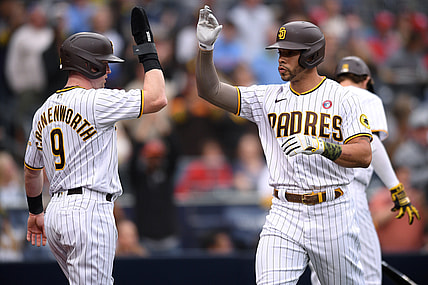 May 15, 2021; San Diego, California, USA; San Diego Padres left fielder Tommy Pham (R) is congratulated by  second baseman Jake Cronenworth (9) after hitting a two-run home run against the St. Louis Cardinals during the first inning at Petco Park. Mandatory Credit: Orlando Ramirez-USA TODAY Sports